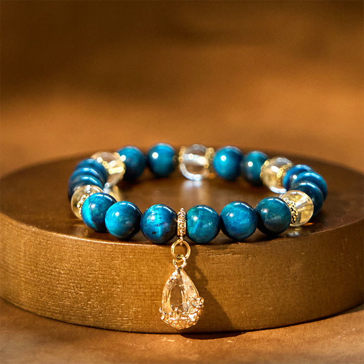 Bracelet de force en forme de goutte d'eau en cristal blanc et œil de tigre bleu Buddha Stones
