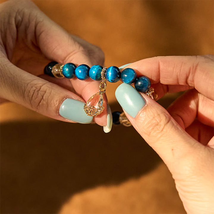 Bracelet de force en forme de goutte d'eau en cristal blanc et œil de tigre bleu Buddha Stones