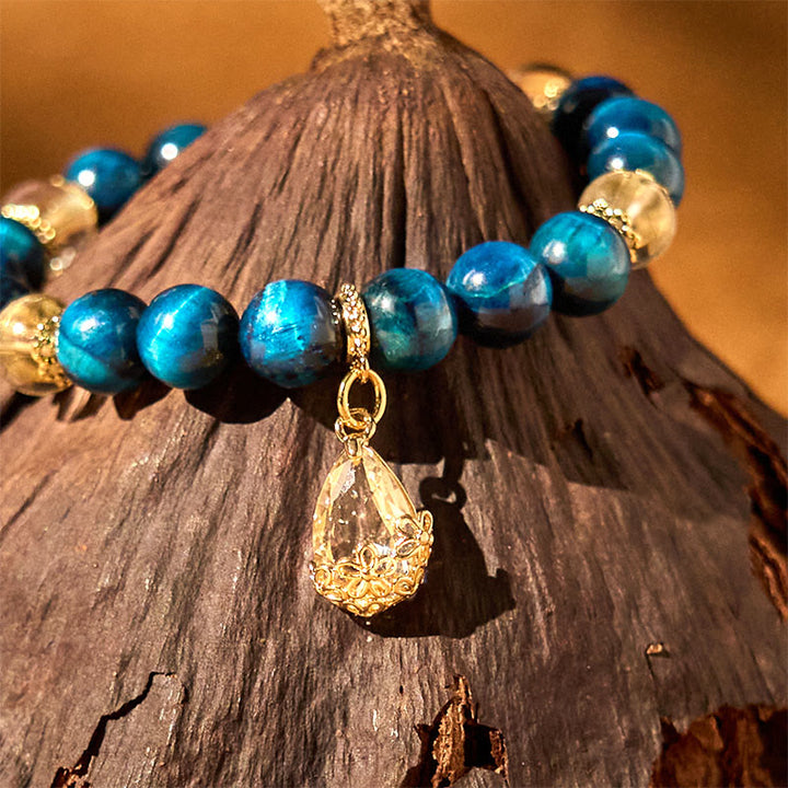 Bracelet de force en forme de goutte d'eau en cristal blanc et œil de tigre bleu Buddha Stones
