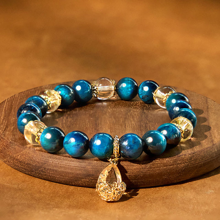 Bracelet de force en forme de goutte d'eau en cristal blanc et œil de tigre bleu Buddha Stones