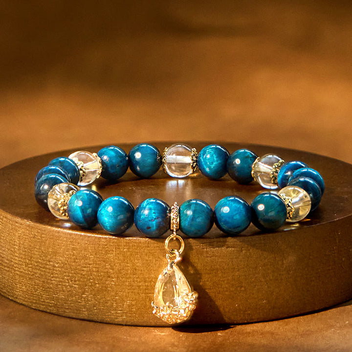Bracelet de force en forme de goutte d'eau en cristal blanc et œil de tigre bleu Buddha Stones