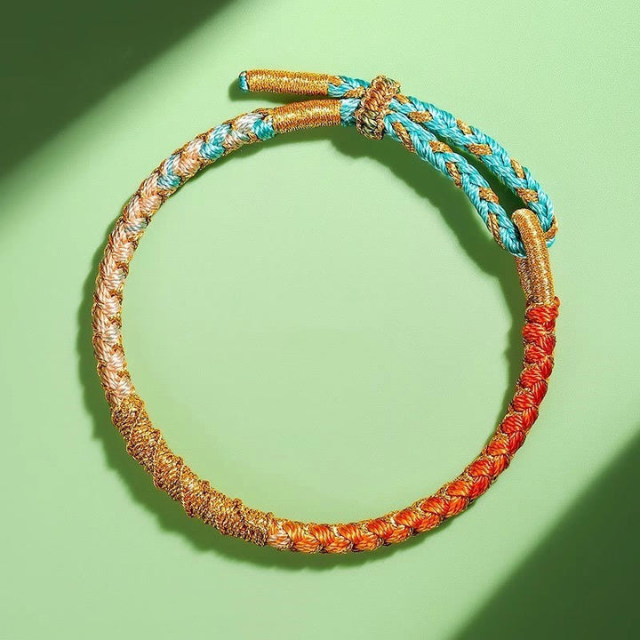 Bracelet tressé de protection en fil d'or coloré tibétain avec Buddha Stones et nœud en écailles de dragon