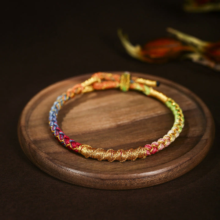 Bracelet tressé de protection en fil d'or coloré tibétain avec Buddha Stones et nœud en écailles de dragon