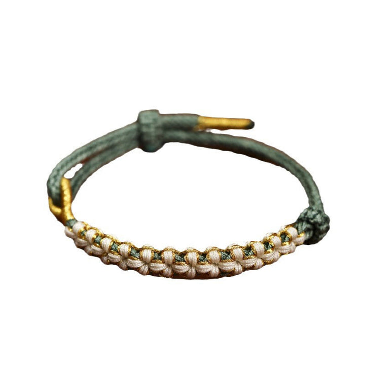 Bracelet tressé en fil d'or tibétain avec Buddha Stones et nœuds colorés en fleurs de pêcher