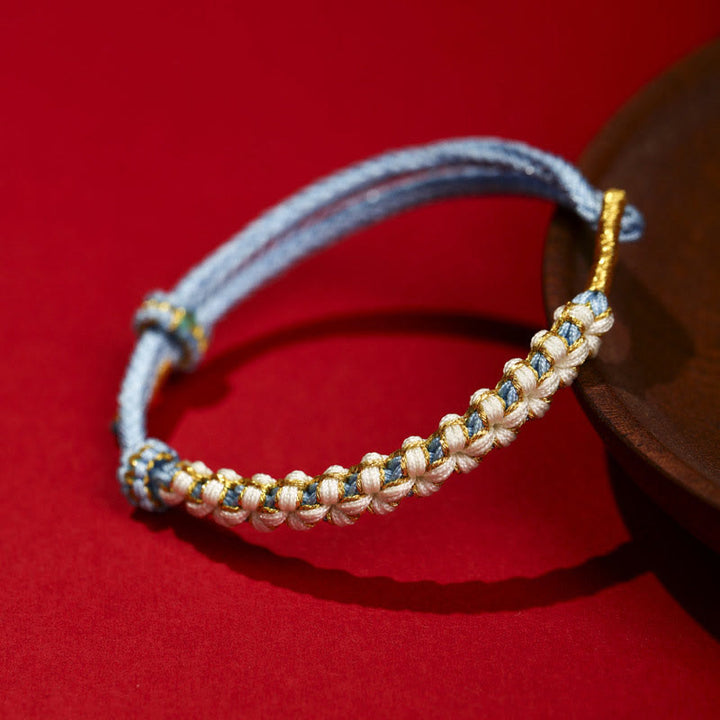 Bracelet tressé en fil d'or tibétain avec Buddha Stones et nœuds colorés en fleurs de pêcher