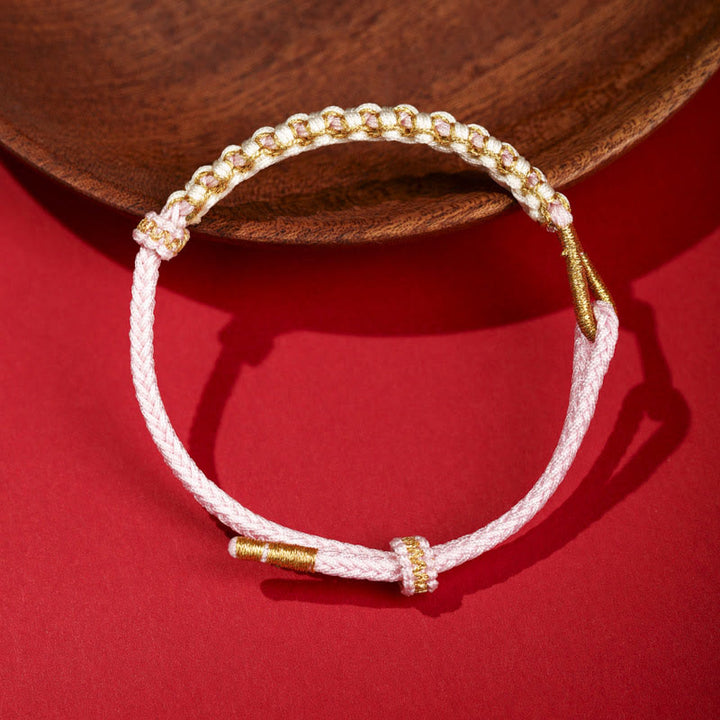Bracelet tressé en fil d'or tibétain avec Buddha Stones et nœuds colorés en fleurs de pêcher