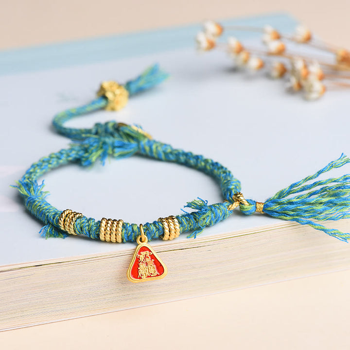 Bracelet tibétain en Buddha Stones avec pompon en forme de fleur et de déesse de la richesse Zakiram