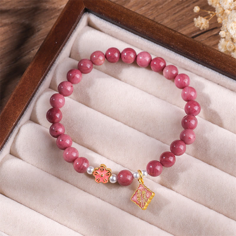 Bracelet d'énergie aimante en rhodonite et fleur de pêcher de Buddha Stones