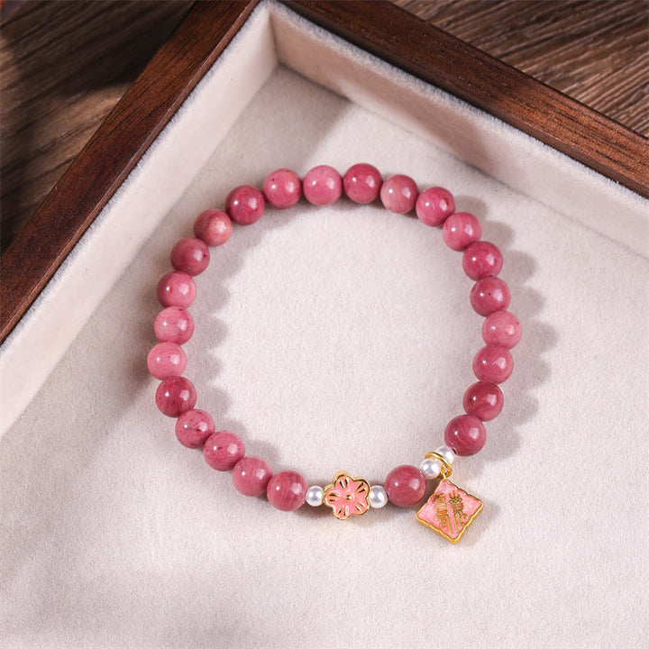 Bracelet d'énergie aimante en rhodonite et fleur de pêcher de Buddha Stones