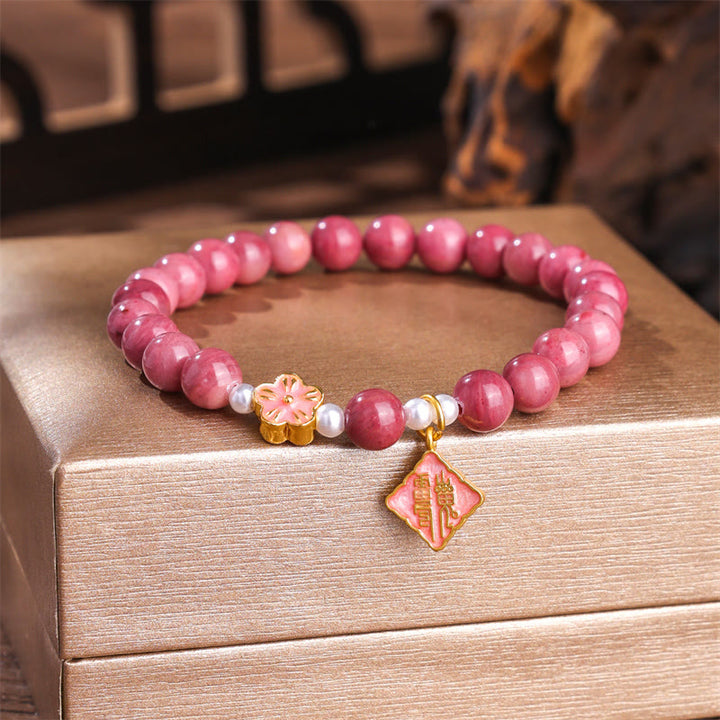 Bracelet d'énergie aimante en rhodonite et fleur de pêcher de Buddha Stones