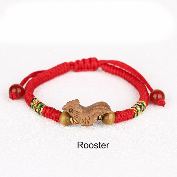 Bracelet porte-bonheur en bois de pêcher avec cordon rouge et signe du zodiaque chinois fait main par Buddha Stones