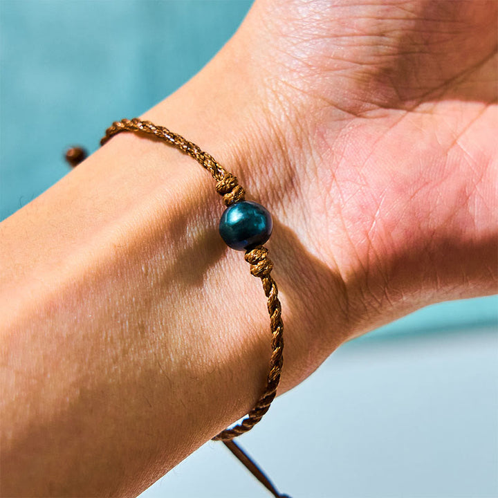 Bracelet de sagesse en corde cirée avec perles noires naturelles de Tahiti et Buddha Stones