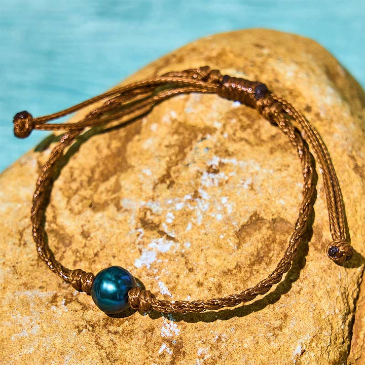 Bracelet de sagesse en corde cirée avec perles noires naturelles de Tahiti et Buddha Stones