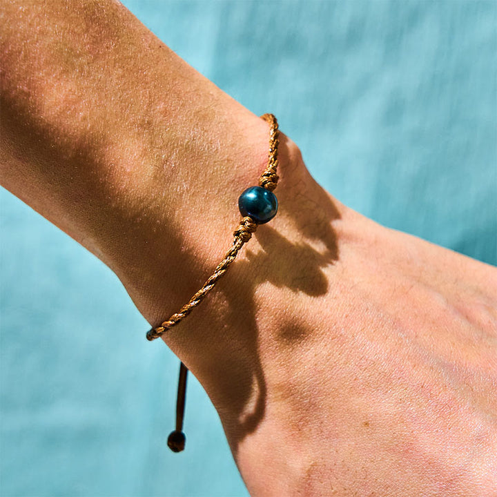 Bracelet de sagesse en corde cirée avec perles noires naturelles de Tahiti et Buddha Stones
