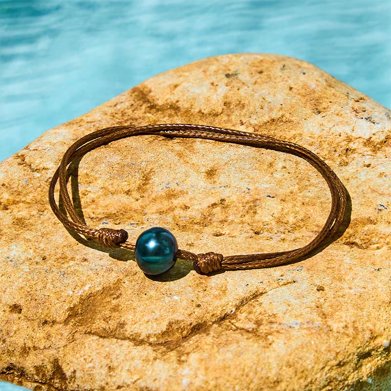 Bracelet de guérison en corde de cire avec perles noires naturelles de Tahiti et Buddha Stones