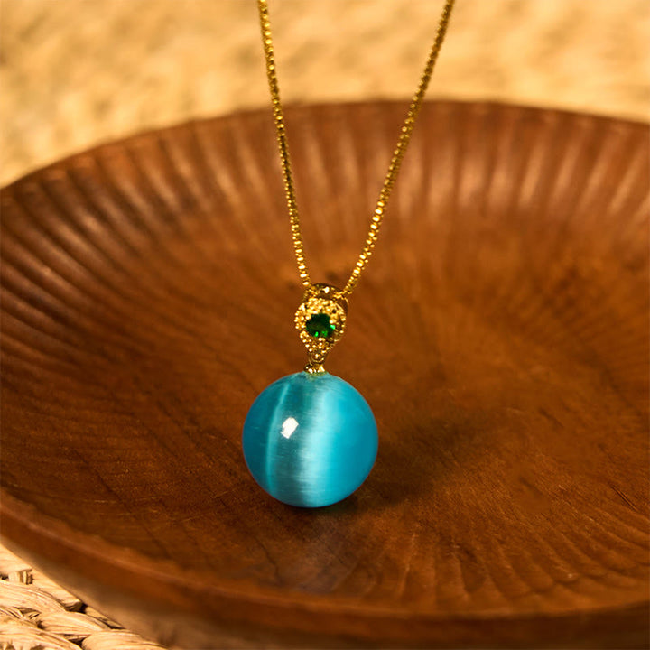 Collier avec pendentif boule ronde œil de chat en Buddha Stones