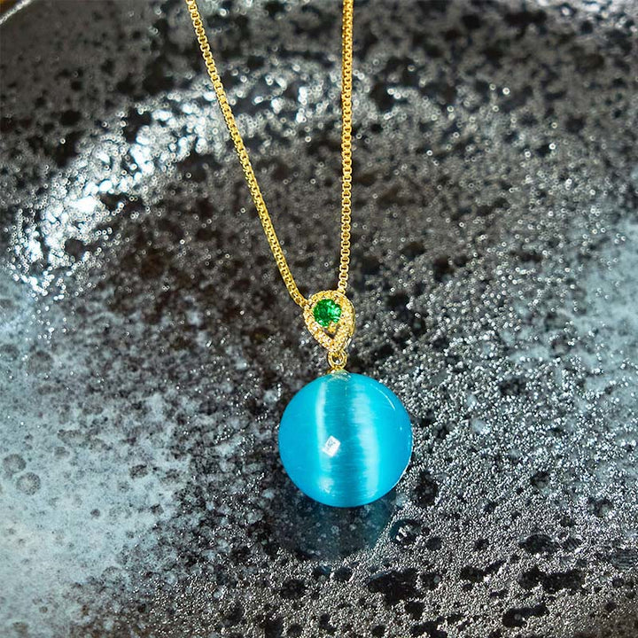 Collier avec pendentif boule ronde œil de chat en Buddha Stones