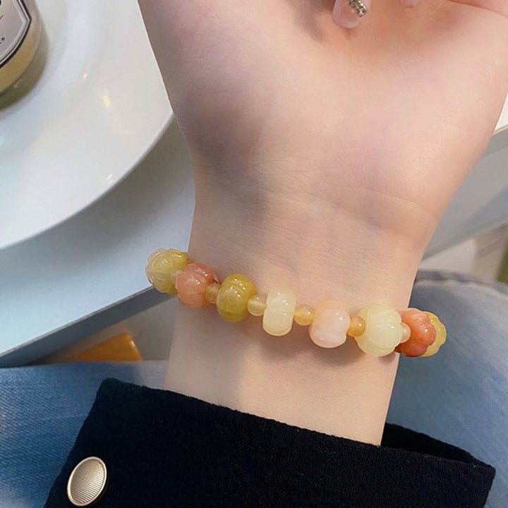 Bracelet Buddha Stones, soie dorée, jade, perles citrouille, richesse, chance