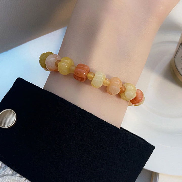 Bracelet Buddha Stones, soie dorée, jade, perles citrouille, richesse, chance