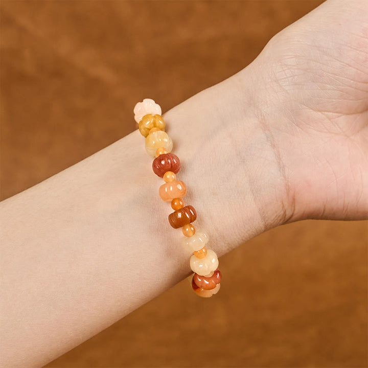 Bracelet Buddha Stones, soie dorée, jade, perles citrouille, richesse, chance