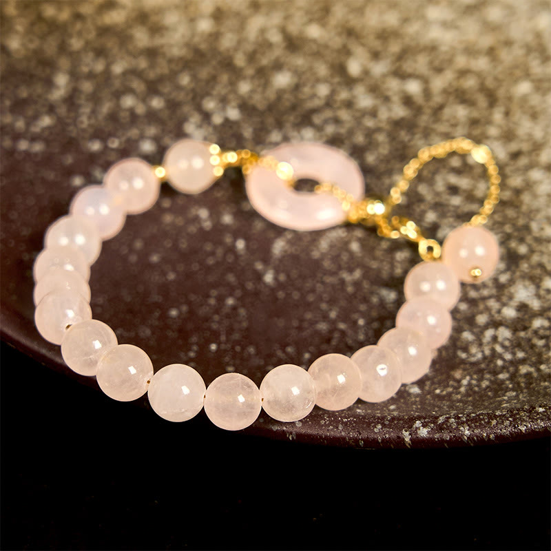 Bracelet d'acceptation de soi avec boucle de paix et perles de cristal rose naturel en Buddha Stones
