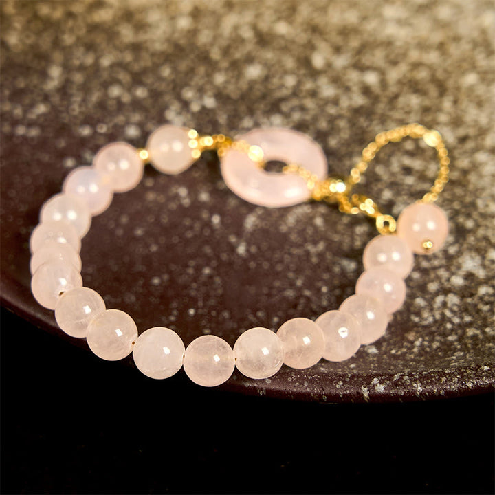 Bracelet d'acceptation de soi avec boucle de paix et perles de cristal rose naturel en Buddha Stones