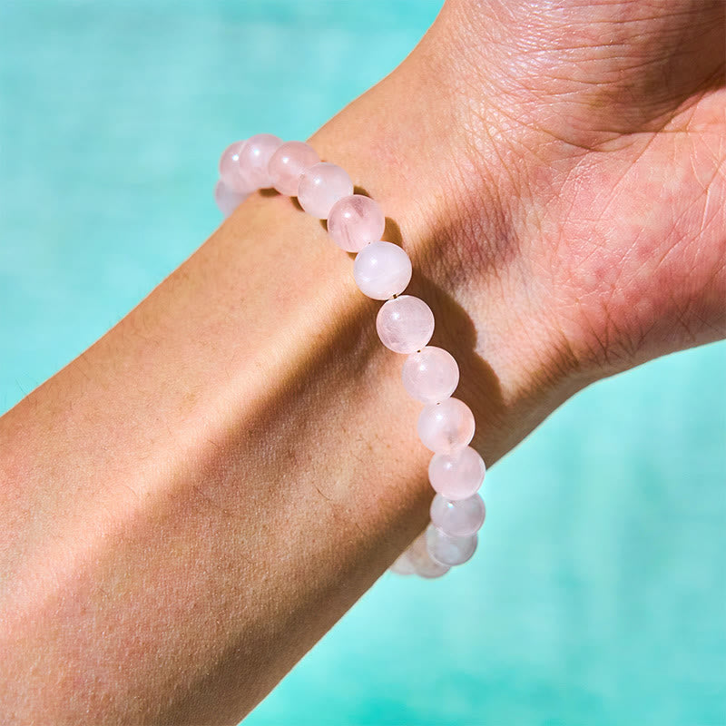 Bracelet d'acceptation de soi avec boucle de paix et perles de cristal rose naturel en Buddha Stones