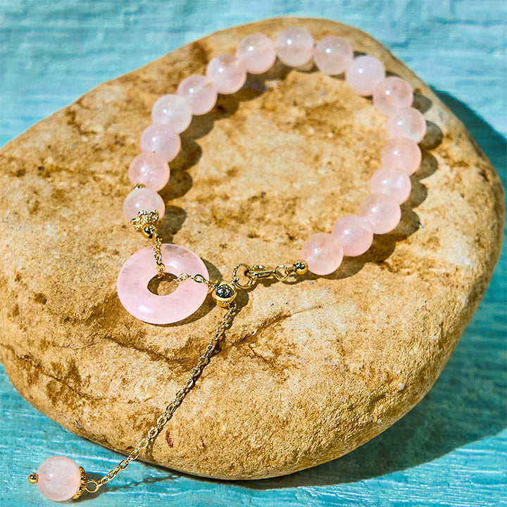 Bracelet d'acceptation de soi avec boucle de paix et perles de cristal rose naturel en Buddha Stones