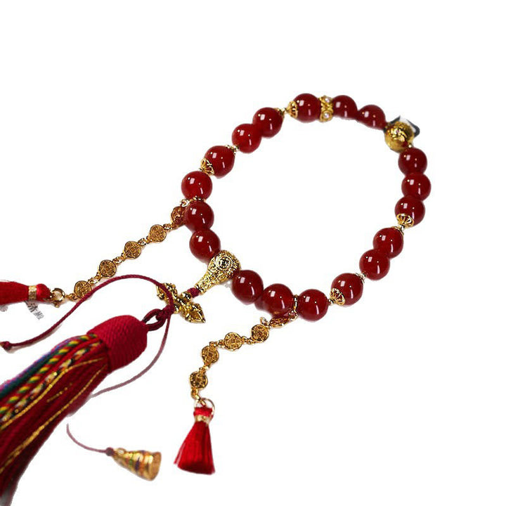 Mala de poignet calme en agate rouge et Buddha Stones , 18 perles en cuivre et pompon tibétain