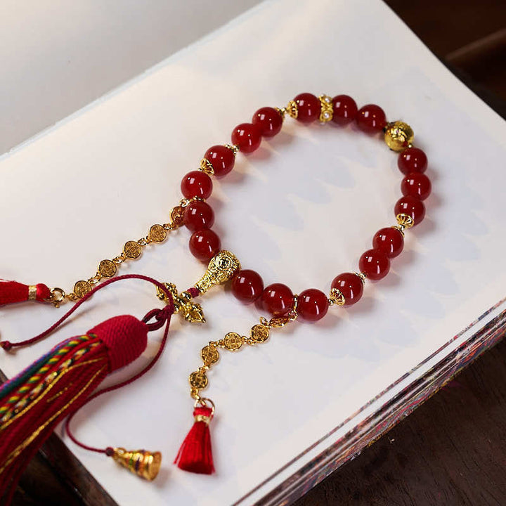 Mala de poignet calme en agate rouge et Buddha Stones , 18 perles en cuivre et pompon tibétain