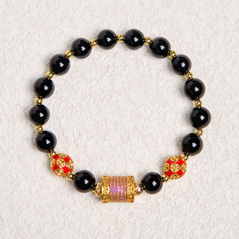 Bracelet porte-bonheur en Buddha Stones noir naturel et cinq pièces de cuivre sacrées