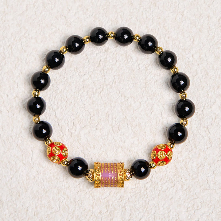 Bracelet porte-bonheur en Buddha Stones noir naturel et cinq pièces de cuivre sacrées