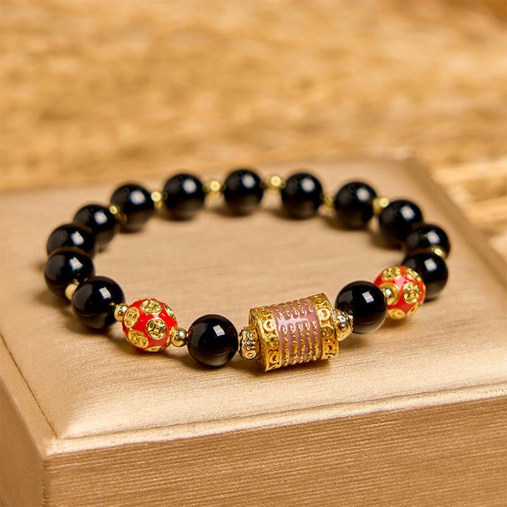 Bracelet porte-bonheur en Buddha Stones noir naturel et cinq pièces de cuivre sacrées