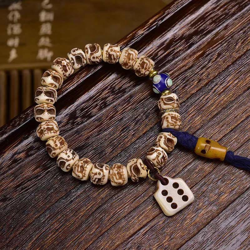 Bracelet tibétain à pompon sculpté en Buddha Stones