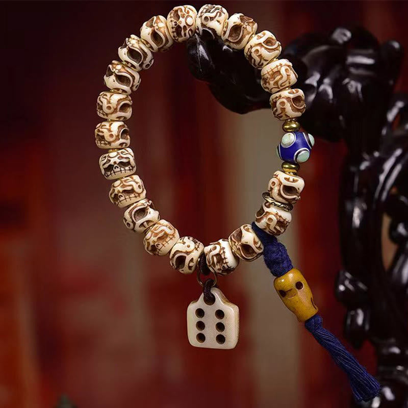 Bracelet tibétain à pompon sculpté en Buddha Stones