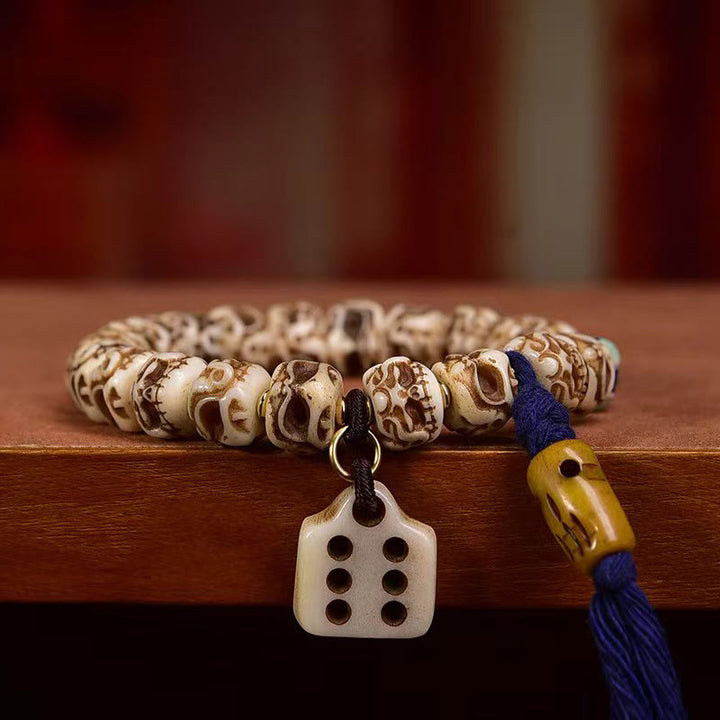 Bracelet tibétain à pompon sculpté en Buddha Stones