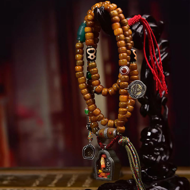 Mala tibétain à 108 perles en os de chameau et pompon porte-bonheur en Buddha Stones