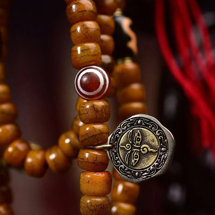 Mala tibétain à 108 perles en os de chameau et pompon porte-bonheur en Buddha Stones