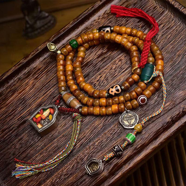 Mala tibétain à 108 perles en os de chameau et pompon porte-bonheur en Buddha Stones