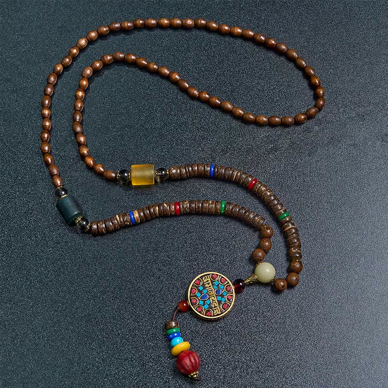Buddha Stones pendentif en perles de cuivre et mantra lumineux en bois de schima, fait à la main en coquille de noix de coco tibétaine