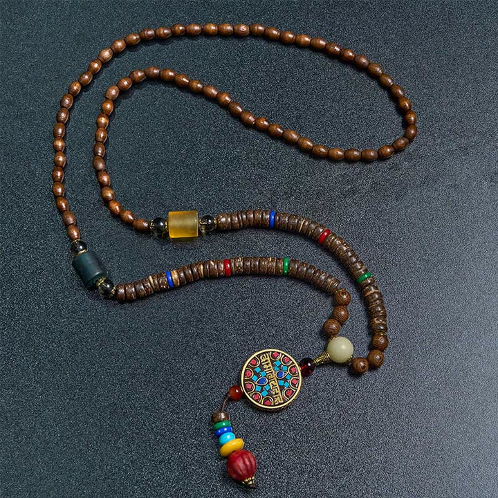 Buddha Stones pendentif en perles de cuivre et mantra lumineux en bois de schima, fait à la main en coquille de noix de coco tibétaine