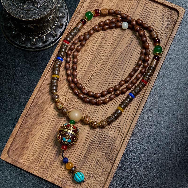 Buddha Stones pendentif en perles de cuivre et mantra lumineux en bois de schima, fait à la main en coquille de noix de coco tibétaine