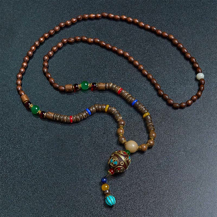 Buddha Stones pendentif en perles de cuivre et mantra lumineux en bois de schima, fait à la main en coquille de noix de coco tibétaine