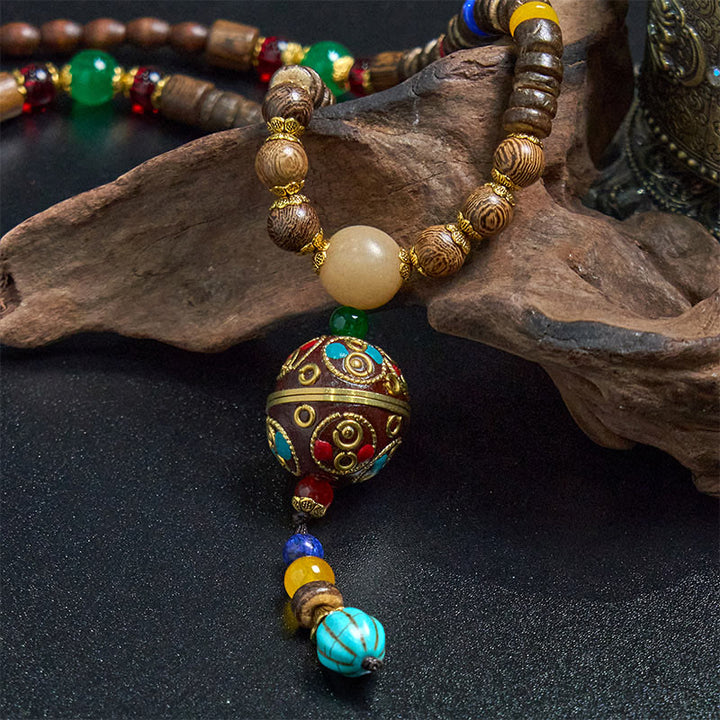 Buddha Stones pendentif en perles de cuivre et mantra lumineux en bois de schima, fait à la main en coquille de noix de coco tibétaine