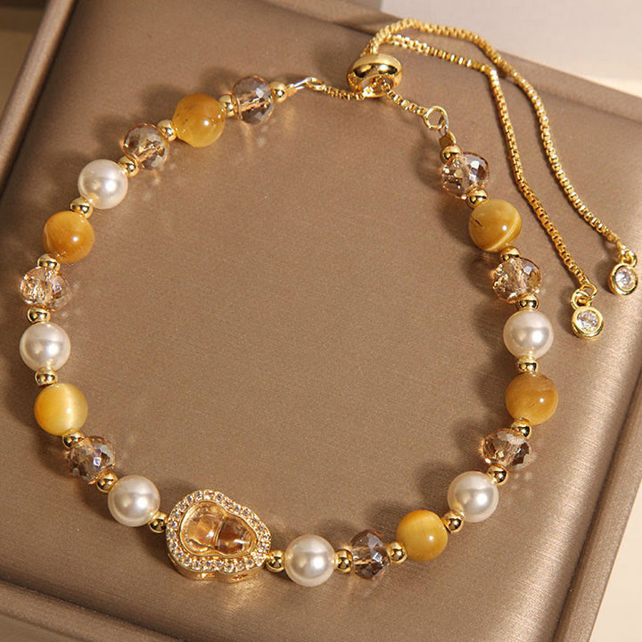 Bracelet de prospérité en pierre œil de chat jaune et perle de calebasse - image 2