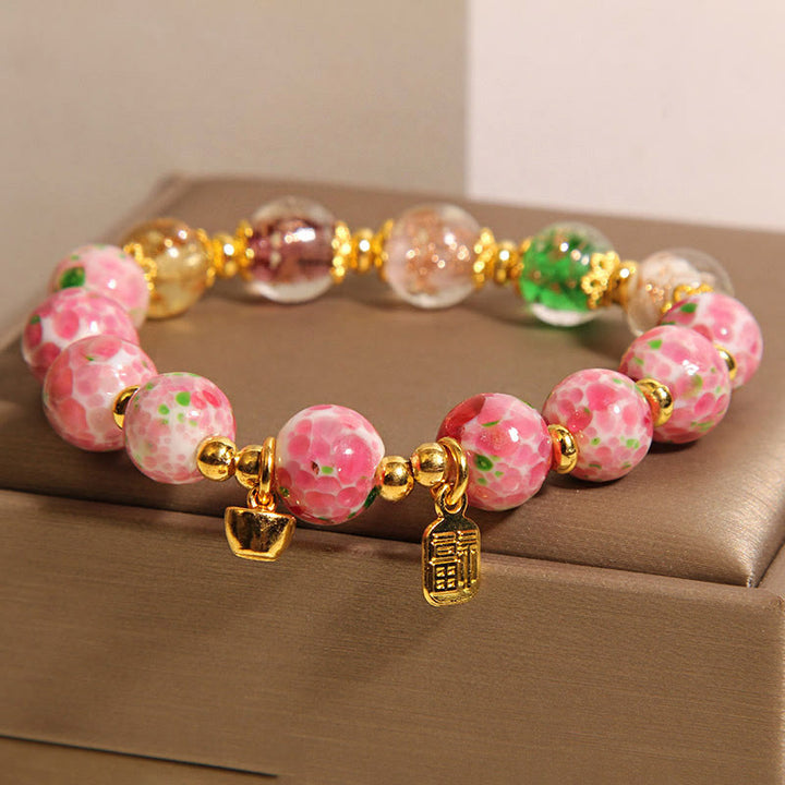 Bracelet porte-bonheur Liuli rose Buddha Stones et personnage Fu - image 1