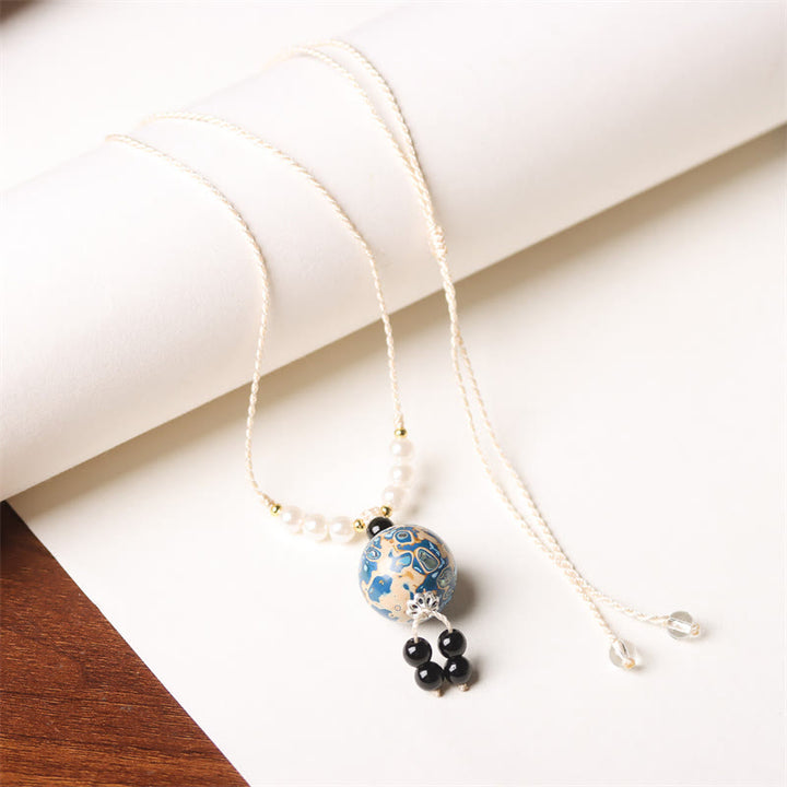 Collier pendentif en perles artisanales en bois d'ébène et laque Aurora , Buddha Stones - Breloque bleu blanc (bleu blanc aléatoire) - image 11