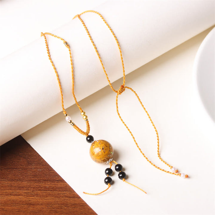 Collier pendentif en perles artisanales en bois d'ébène et laque Aurora , Buddha Stones - Charme doré (doré aléatoire) - image 14