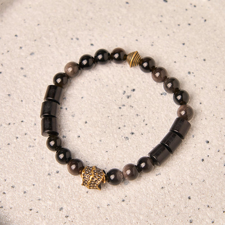 Bracelet de protection en obsidienne et ébène avec Buddha Stones et reflets argentés - image 1