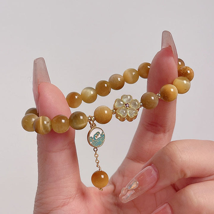 Bracelet courage en forme de clochette et œil de tigre doré naturel Buddha Stones - image 9